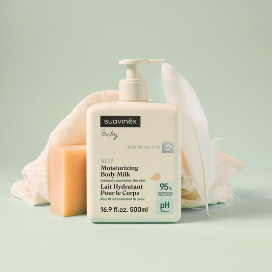 Suavinex baby moisturizing body milk bottle on a light green background