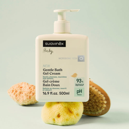 Suavinex baby gentle bath gel-cream with natural sponges on a light green background